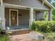 Lovely home showcasing a porch with swing, a wood door, and charming curb appeal at 1514 S Rensselaer Pl, Charlotte, NC 28203