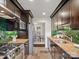 Well designed kitchen features stainless appliances, green backsplash and view of dining room at 1514 S Rensselaer Pl, Charlotte, NC 28203