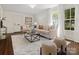 Bright living room with a modern sofa, plush rug, and natural light through large windows at 1514 S Rensselaer Pl, Charlotte, NC 28203