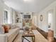 Bright living room featuring a modern sofa, hardwood floors, and open access to other rooms at 1514 S Rensselaer Pl, Charlotte, NC 28203