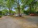 Off-street parking area surrounded by mature trees and landscaping adjacent to homes at 1514 S Rensselaer Pl, Charlotte, NC 28203