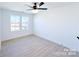 Bedroom with two windows and a ceiling fan, hardwood floors, and white walls with white trim at 1525 Solitude Ct, Kannapolis, NC 28081