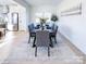 Dining area with a table set for six, flowing into an open kitchen with stainless appliances at 1525 Solitude Ct, Kannapolis, NC 28081