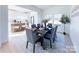 Dining area with a table set for six, flowing into an open kitchen with stainless appliances at 1525 Solitude Ct, Kannapolis, NC 28081