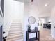 Bright entryway with stairs, a table with decor, and an open view to the dining and kitchen areas at 1525 Solitude Ct, Kannapolis, NC 28081