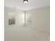 Bright bedroom with two windows and neutral shades for a minimalist and airy feel, ready for personalization at 15814 Herring Gull Way, Charlotte, NC 28278
