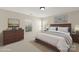 Comfortable bedroom featuring warm colors, a wooden bed frame, and serene decor creating a peaceful atmosphere at 15814 Herring Gull Way, Charlotte, NC 28278