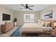 A bedroom is staged with stylish furniture, a sleek TV, and soothing wall art for a modern aesthetic at 15814 Herring Gull Way, Charlotte, NC 28278
