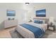 Staged bedroom featuring a plush bed, blue accents, stylish furniture, and serene wall art for a calming retreat at 15814 Herring Gull Way, Charlotte, NC 28278