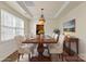 Elegant dining room with a wooden table, comfortable chairs, and decorative art at 15814 Herring Gull Way, Charlotte, NC 28278