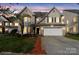 Charming two-story home featuring brick and siding exterior, a two-car garage, and a well-manicured front yard at 15814 Herring Gull Way, Charlotte, NC 28278