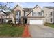Charming two-story home featuring brick and siding exterior, a two-car garage, and a well-manicured front yard at 15814 Herring Gull Way, Charlotte, NC 28278