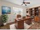 Home office with hardwood floors, a ceiling fan, a window, and a built-in bookcase at 15814 Herring Gull Way, Charlotte, NC 28278
