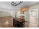 Open kitchen featuring an island, wood cabinets, stainless steel appliances, and modern lighting fixtures above the island at 15814 Herring Gull Way, Charlotte, NC 28278