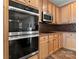 Modern kitchen with stainless steel appliances including a double oven, microwave, and updated cabinetry at 15814 Herring Gull Way, Charlotte, NC 28278