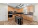 Modern kitchen with light wood cabinets, a black island, and stainless steel appliances at 15814 Herring Gull Way, Charlotte, NC 28278
