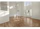 A bright, open living room with high ceilings, large windows, and beautiful hardwood floors at 15814 Herring Gull Way, Charlotte, NC 28278