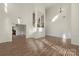 Spacious living room with hardwood floors, wainscoting, and a staircase at 15814 Herring Gull Way, Charlotte, NC 28278
