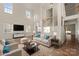 Bright living room with soaring ceilings, hardwood floors, natural light, and comfortable furniture at 15814 Herring Gull Way, Charlotte, NC 28278