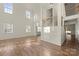 A bright, open living room featuring soaring ceilings, hardwood floors, and natural light at 15814 Herring Gull Way, Charlotte, NC 28278