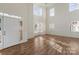 A bright, open living room with high ceilings, large windows, and beautiful hardwood floors at 15814 Herring Gull Way, Charlotte, NC 28278