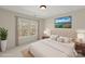 Stylishly staged bedroom featuring a neutral palette and lots of natural light at 15814 Herring Gull Way, Charlotte, NC 28278