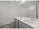 Bathroom boasts a double vanity with quartz countertops, modern fixtures, and wood-look tile flooring at 15910 Parkside Crossing Dr # 318, Charlotte, NC 28278