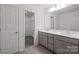 Bathroom with double vanity, quartz countertops, modern fixtures, and wood-look tile flooring at 15910 Parkside Crossing Dr # 318, Charlotte, NC 28278