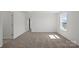 Bright bedroom with neutral carpet, white walls, and a window letting in natural light at 15910 Parkside Crossing Dr # 318, Charlotte, NC 28278