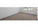 Bedroom features neutral carpet and natural light from a window at 15910 Parkside Crossing Dr # 318, Charlotte, NC 28278
