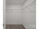 A walk-in closet features wire shelving providing ample storage space at 15910 Parkside Crossing Dr # 318, Charlotte, NC 28278