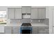 New kitchen featuring stainless steel gas range and decorative backsplash at 15910 Parkside Crossing Dr # 318, Charlotte, NC 28278