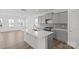 Kitchen with large island, stylish gray cabinets and stainless steel gas range at 15910 Parkside Crossing Dr # 318, Charlotte, NC 28278