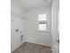 Bright laundry room with tile floors, a wire rack shelf, and a window for natural light at 15910 Parkside Crossing Dr # 318, Charlotte, NC 28278
