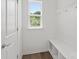 Mudroom includes a built-in bench with cubbies and a window for natural light at 15910 Parkside Crossing Dr # 318, Charlotte, NC 28278