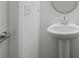 Powder room features a pedestal sink and modern fixtures at 15910 Parkside Crossing Dr # 318, Charlotte, NC 28278