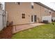 Backyard featuring a brick patio and an installed AC unit at 16631 Commons Creek Dr, Charlotte, NC 28277