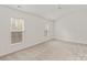 View of bedroom featuring neutral colored walls, carpet and large windows letting in natural light at 16631 Commons Creek Dr, Charlotte, NC 28277