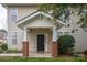 Inviting entrance features brick columns, a covered porch, and a well-maintained lawn, creating a welcoming ambiance at 16631 Commons Creek Dr, Charlotte, NC 28277