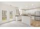 Bright kitchen featuring white cabinets, stainless steel appliances, and an eat-in dining area with outdoor access at 16631 Commons Creek Dr, Charlotte, NC 28277