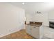 Kitchen view featuring tile floor, white walls, and an island open to the living room with a fireplace at 16631 Commons Creek Dr, Charlotte, NC 28277
