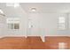 Bright and airy living area with hardwood floors, lots of windows providing natural light, and neutral paint scheme at 16631 Commons Creek Dr, Charlotte, NC 28277