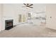Open living room with a fireplace and access to the kitchen and back patio at 16631 Commons Creek Dr, Charlotte, NC 28277