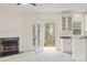 Bright living room with fireplace and access to the outdoor area, complemented by white cabinetry at 16631 Commons Creek Dr, Charlotte, NC 28277