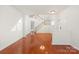 Spacious living room boasts shiny wood floors, natural light, and staircase, creating a warm and inviting atmosphere at 16631 Commons Creek Dr, Charlotte, NC 28277