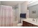 Cozy bathroom with a shower-tub, a vanity with cherry wood cabinets, and neutral gray walls at 168 Limerick Rd # C, Mooresville, NC 28115