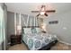 Comfortable bedroom featuring a decorative wall treatment, a ceiling fan, and bedside tables with lamps at 168 Limerick Rd # C, Mooresville, NC 28115