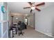 Bedroom area featuring neutral carpet, a ceiling fan, and a gray accent wall with white squares at 168 Limerick Rd # C, Mooresville, NC 28115