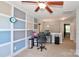 Bright bedroom featuring neutral carpet, a ceiling fan, and a gray accent wall with white squares at 168 Limerick Rd # C, Mooresville, NC 28115