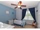 Cozy bedroom featuring a ceiling fan, a comfortable bed with safety rail, and a window at 168 Limerick Rd # C, Mooresville, NC 28115